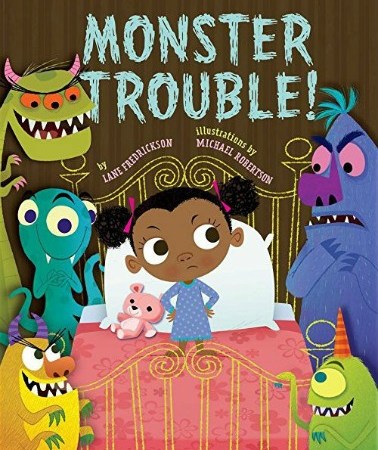 A young Black girl in a blue and purple nightgown stands on a pink bed, looking sternly at the monsters who stand on either side of the bed grinning at her. Text: "Monster Trouble! by Lane Fredrickson illustrations by Michael Robertson."
